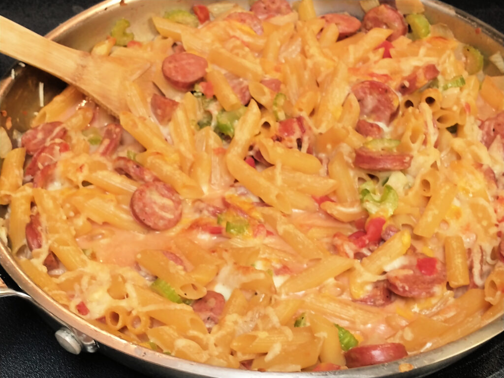 A Creamy dish of Chicken Sausage, Onion, tomato, and celery with a heavy cream and broth base with cheese mixed in a Parmesan on top.  Broiled at the end for just a few minutes to melt the cheese. 