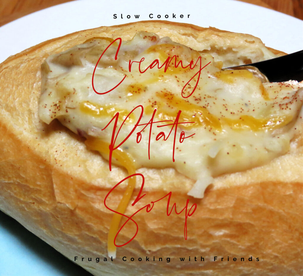Slow Cooker Potato Soup being served in a Bread Bowl, topped with Cheese and Paprika. 